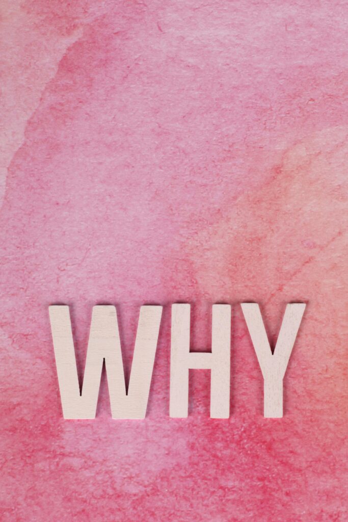 A minimalist art piece featuring the word 'WHY' in bold white letters on a pink gradient background.